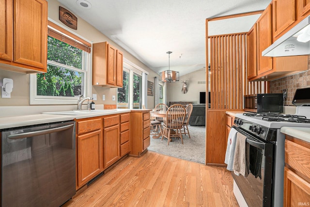 23200 S Oakleaf Dr, Elkhart, IN 46514 - kitchen with black appliances, exhaust hood, light wood-style flooring, light countertops, and a chandelier