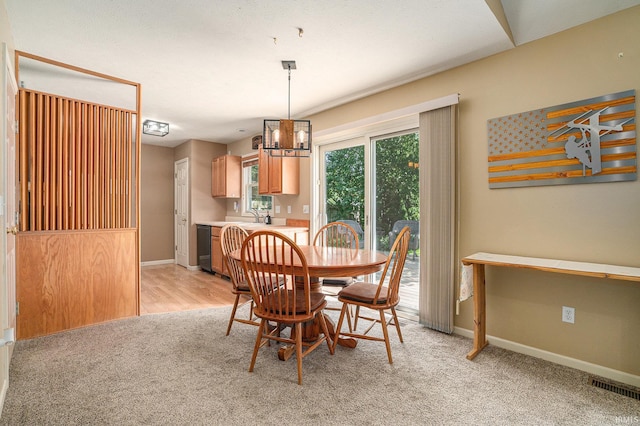23200 S Oakleaf Dr, Elkhart, IN 46514 - dining room with light carpet and a chandelier