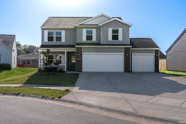 197 Folkston Way, Lafayette, IN 47905 - view of front of house featuring brick siding, covered porch, driveway, a front yard, and a garage