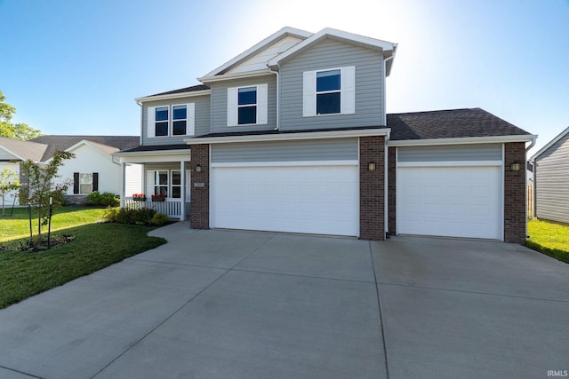 197 Folkston Way, Lafayette, IN 47905 - view of front facade featuring concrete driveway, brick siding, an attached garage, a front yard, and a porch
