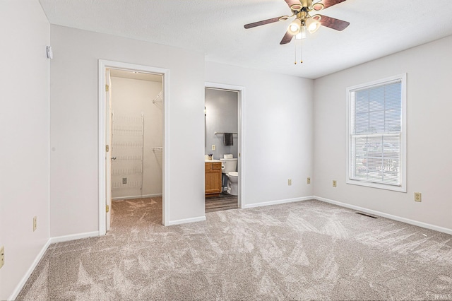4211 Anchor Dr, Mishawaka, IN 46544 - unfurnished bedroom with carpet flooring, connected bathroom, and ceiling fan