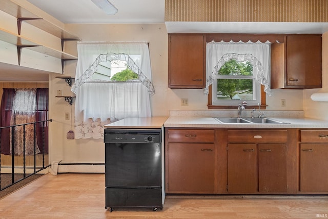 303 N Center St, Boswell, IN 47921 - kitchen with black dishwasher, baseboard heating, light countertops, light wood-type flooring, and brown cabinetry