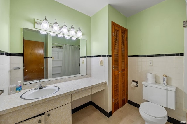 303 N Center St, Boswell, IN 47921 - full bathroom with tile walls, vanity, a wainscoted wall, a closet, and curtained shower