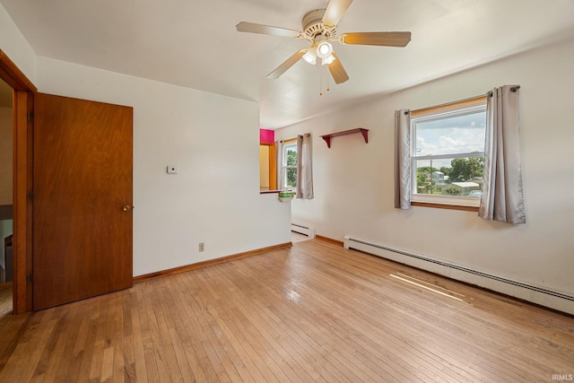 303 N Center St, Boswell, IN 47921 - spare room featuring baseboard heating, hardwood / wood-style flooring, and a ceiling fan