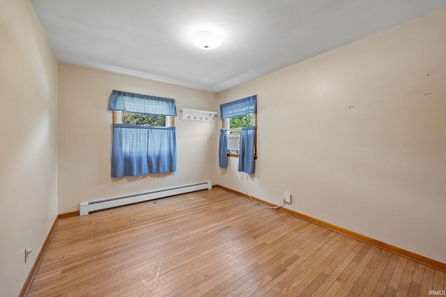 303 N Center St, Boswell, IN 47921 - empty room with baseboard heating and wood-type flooring