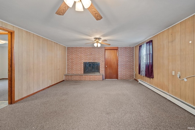 303 N Center St, Boswell, IN 47921 - unfurnished living room with ceiling fan, a baseboard heating unit, wood walls, carpet floors, and a brick fireplace