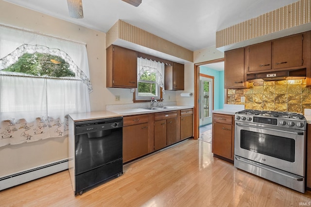 303 N Center St, Boswell, IN 47921 - kitchen with gas stove, baseboard heating, black dishwasher, light countertops, and under cabinet range hood