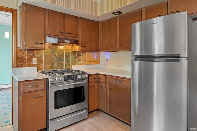 303 N Center St, Boswell, IN 47921 - kitchen featuring appliances with stainless steel finishes, light countertops, decorative backsplash, and brown cabinetry