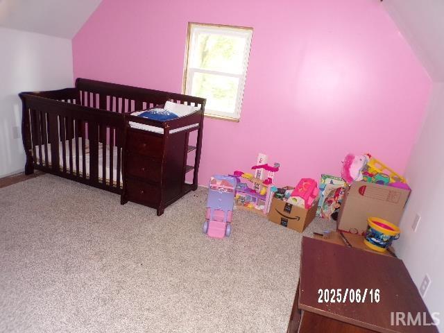 2401 S Selby St, Marion, IN 46953 - bedroom featuring a nursery area, carpet floors, and vaulted ceiling