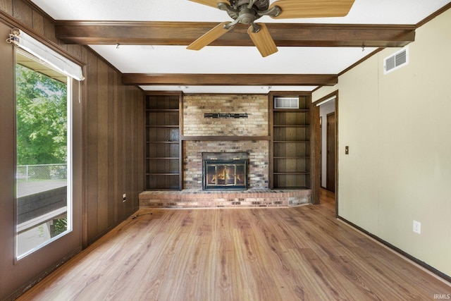 5610 E State Blvd, Fort Wayne, IN 46815 - unfurnished living room with plenty of natural light, light wood-style flooring, beam ceiling, built in features, and wooden walls