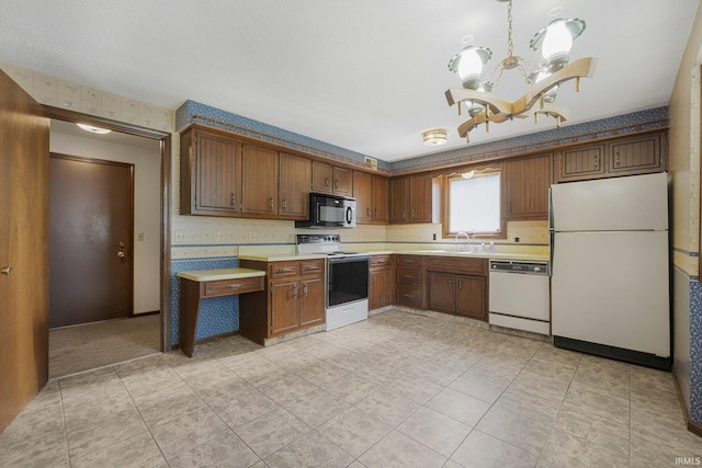 5610 E State Blvd, Fort Wayne, IN 46815 - kitchen with white appliances, light countertops, a chandelier, and light tile patterned floors