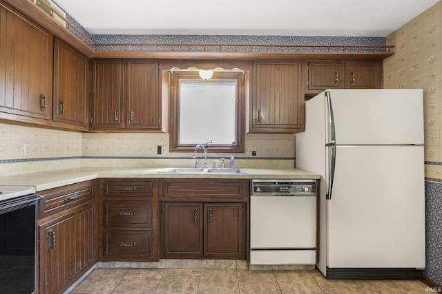 5610 E State Blvd, Fort Wayne, IN 46815 - kitchen with white appliances, light countertops, wallpapered walls, and tasteful backsplash