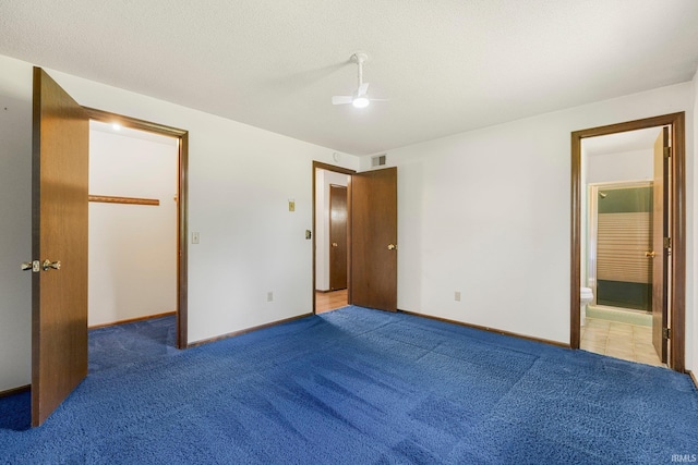 5610 E State Blvd, Fort Wayne, IN 46815 - unfurnished bedroom with a spacious closet, carpet, ensuite bathroom, and ceiling fan