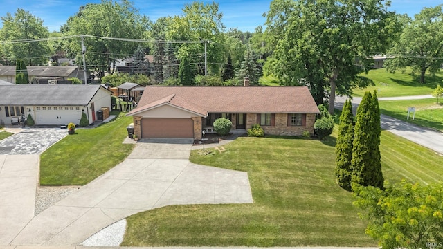5610 E State Blvd, Fort Wayne, IN 46815 - ranch-style home with a front yard, an attached garage, brick siding, and concrete driveway