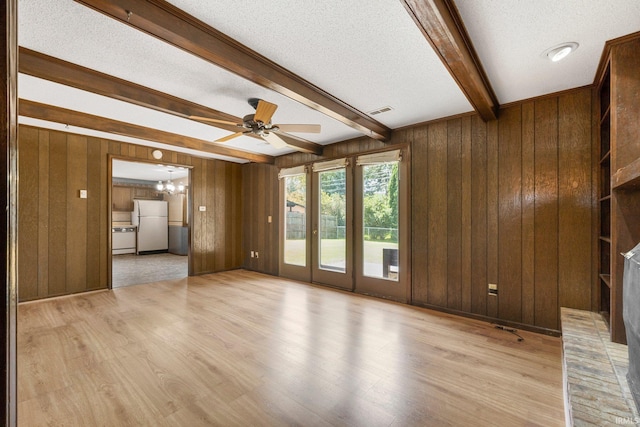 5610 E State Blvd, Fort Wayne, IN 46815 - unfurnished living room featuring beamed ceiling, light wood-style flooring, wood walls, a textured ceiling, and ceiling fan