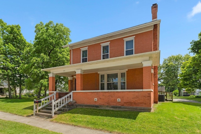 408 E Main St, Butler, IN 46721 - traditional style home featuring brick siding, a porch, a front lawn, and a chimney