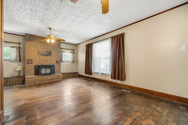 408 E Main St, Butler, IN 46721 - unfurnished living room with a ceiling fan, hardwood / wood-style flooring, crown molding, and a brick fireplace