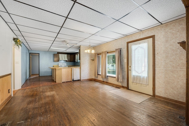 408 E Main St, Butler, IN 46721 - kitchen featuring a drop ceiling, dark wood-style floors, a peninsula, a chandelier, and electric range
