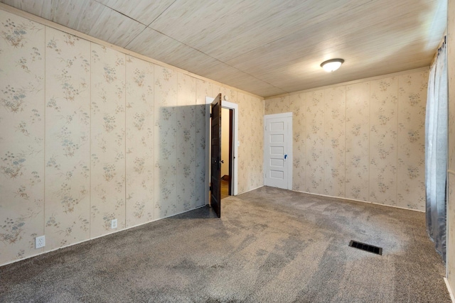 408 E Main St, Butler, IN 46721 - carpeted empty room featuring wallpapered walls and wooden ceiling