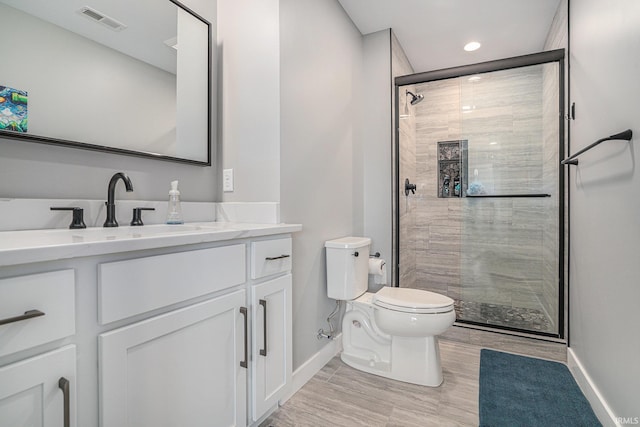 18419 Donegal Dr, South Bend, IN 46637 - bathroom with a stall shower, vanity, wood finished floors, and recessed lighting
