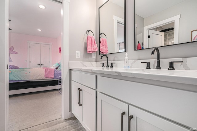 18419 Donegal Dr, South Bend, IN 46637 - ensuite bathroom with double vanity, wood finished floors, and recessed lighting
