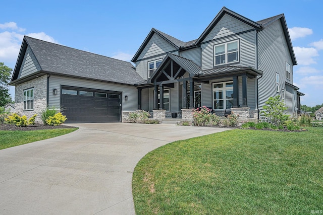 18419 Donegal Dr, South Bend, IN 46637 - view of front of home with stone siding, a garage, concrete driveway, a front lawn, and a standing seam roof