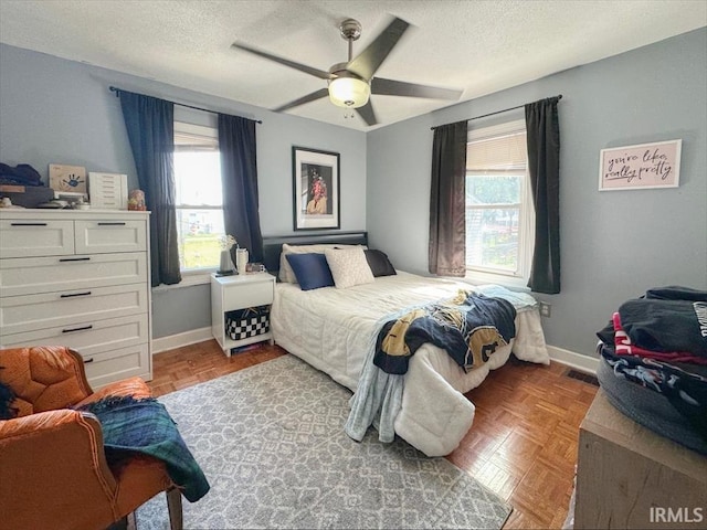 706 E Hoffer St, Kokomo, IN 46902 - bedroom featuring multiple windows, a textured ceiling, and a ceiling fan