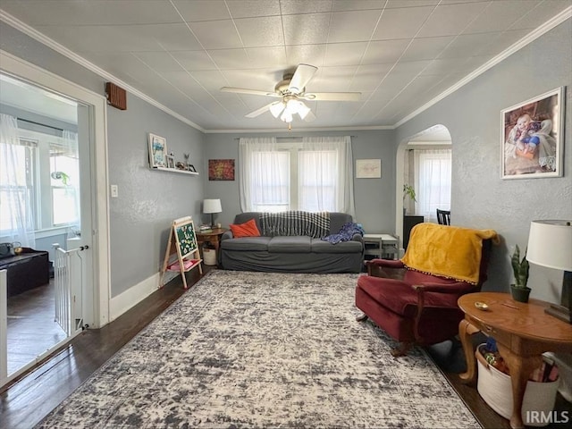706 E Hoffer St, Kokomo, IN 46902 - living room featuring arched walkways, crown molding, a ceiling fan, wood finished floors, and a textured wall