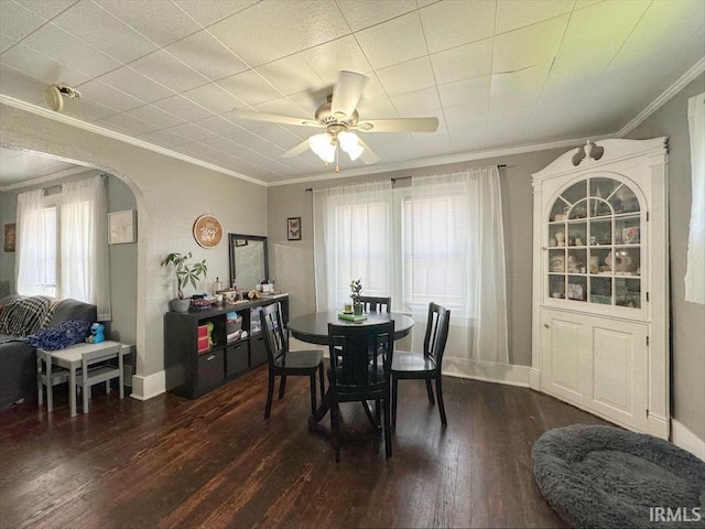 706 E Hoffer St, Kokomo, IN 46902 - dining space with arched walkways, crown molding, wood-type flooring, ceiling fan, and healthy amount of natural light