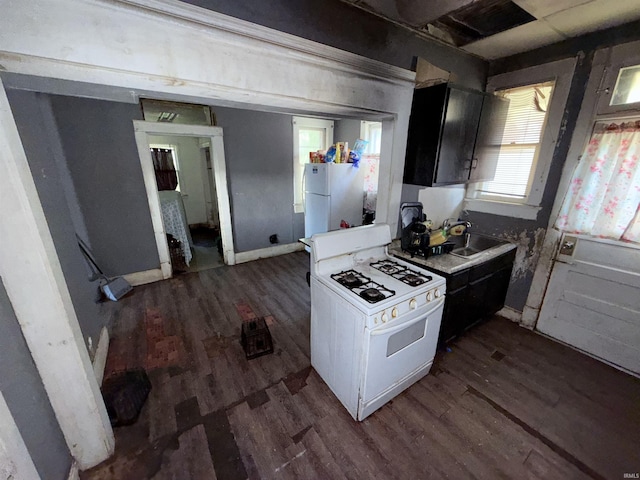 1800 High St, Logansport, IN 46947 - kitchen featuring white appliances, dark wood finished floors, and light countertops