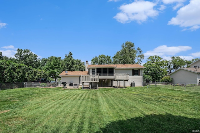 26946 Heather Ln, Elkhart, IN 46514 - rear view of house with a fenced backyard, a sunroom, a chimney, and a patio