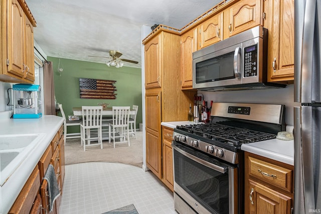 26946 Heather Ln, Elkhart, IN 46514 - kitchen featuring stainless steel appliances, light colored carpet, light countertops, and a ceiling fan