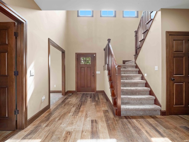188 Begonia Ct, Fort Wayne, IN 46814 - foyer featuring stairs, light wood finished floors, plenty of natural light, and a towering ceiling