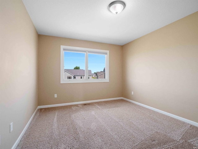 188 Begonia Ct, Fort Wayne, IN 46814 - spare room featuring carpet flooring and baseboards