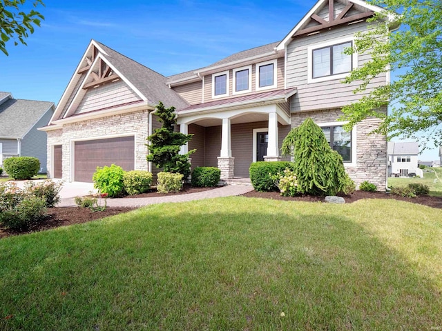 188 Begonia Ct, Fort Wayne, IN 46814 - craftsman-style house with a garage, a front lawn, covered porch, and stone siding