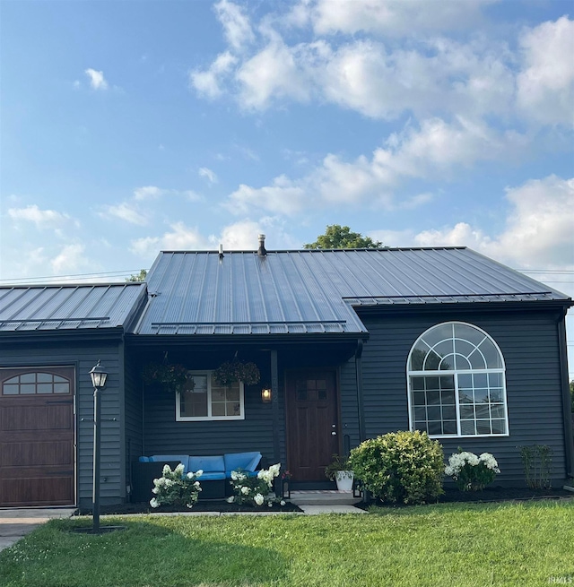 732 Conner Dr, Mishawaka, IN 46544 - single story home with a standing seam roof, a front lawn, an attached garage, and an outdoor living space