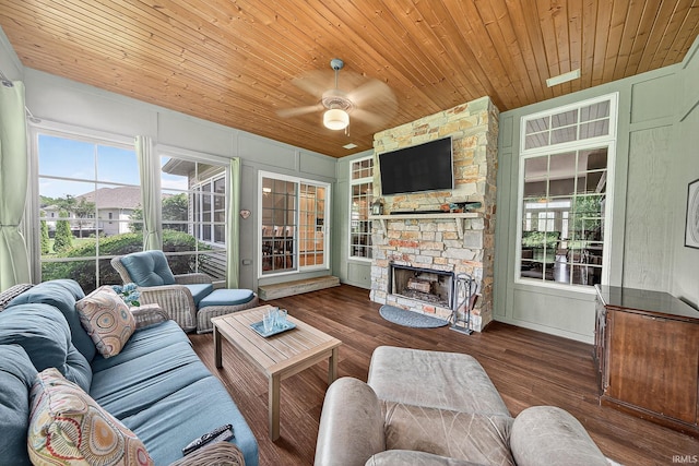 51733 Copperfield Rdg, Granger, IN 46530 - living area with ceiling fan, wooden ceiling, wood finished floors, plenty of natural light, and a stone fireplace