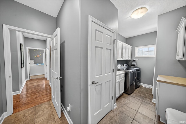 51733 Copperfield Rdg, Granger, IN 46530 - washroom featuring cabinet space, washing machine and clothes dryer, and light tile patterned flooring