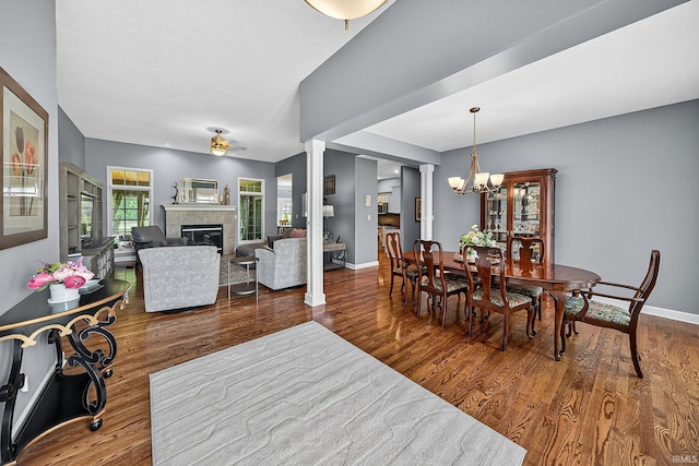51733 Copperfield Rdg, Granger, IN 46530 - dining space with a chandelier, wood finished floors, and a tiled fireplace