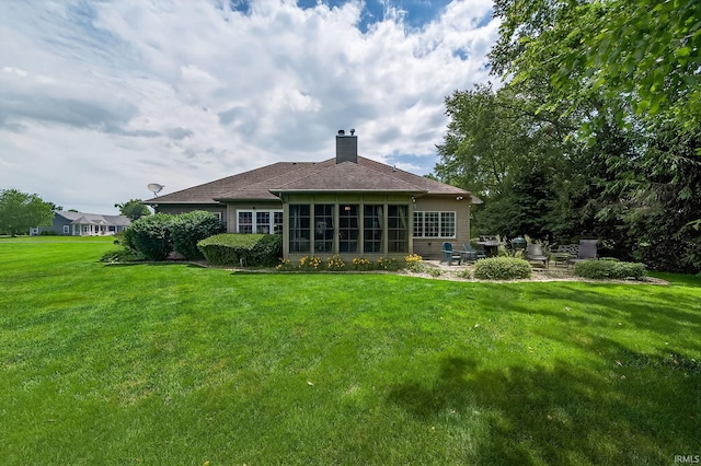 51733 Copperfield Rdg, Granger, IN 46530 - rear view of house featuring a patio area, a chimney, a sunroom, a lawn, and a shingled roof
