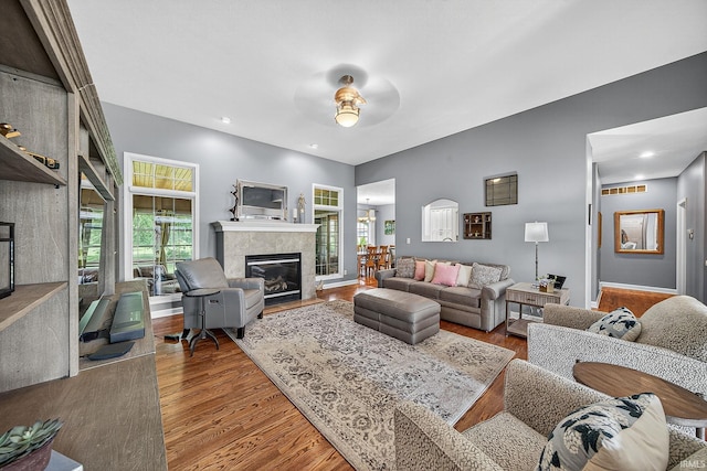 51733 Copperfield Rdg, Granger, IN 46530 - living room featuring wood finished floors, a tile fireplace, and ceiling fan