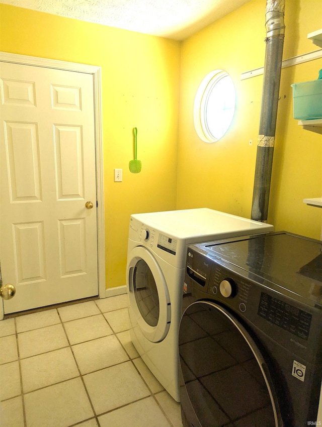 2220 Bobolink Dr, West Lafayette, IN 47906 - laundry area with washing machine and dryer and light tile patterned floors