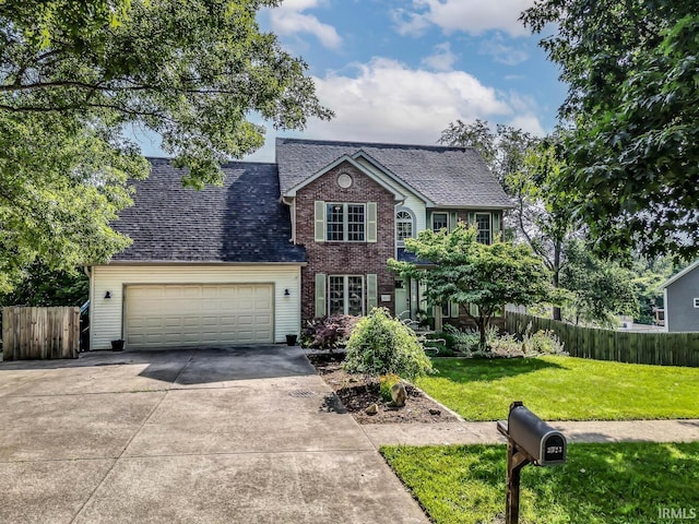 3523 S Tulip Ave, Bloomington, IN 47403 - view of front of house with an attached garage, concrete driveway, a shingled roof, and brick siding