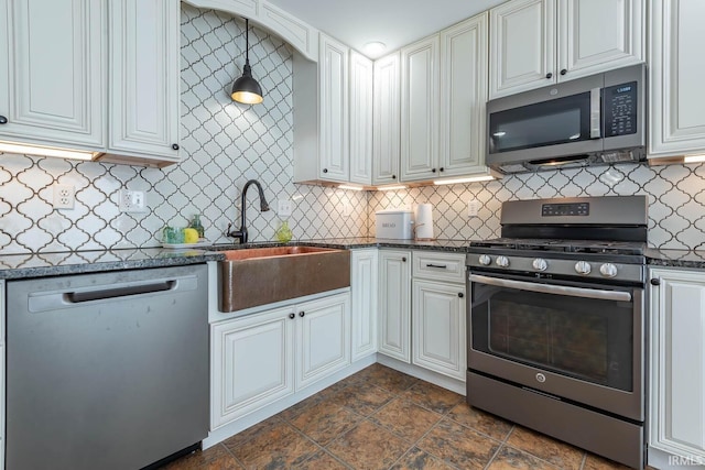 3523 S Tulip Ave, Bloomington, IN 47403 - kitchen with stainless steel appliances, tasteful backsplash, white cabinetry, and dark stone countertops