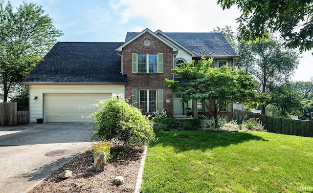 3523 S Tulip Ave, Bloomington, IN 47403 - traditional-style home with an attached garage, driveway, brick siding, and roof with shingles