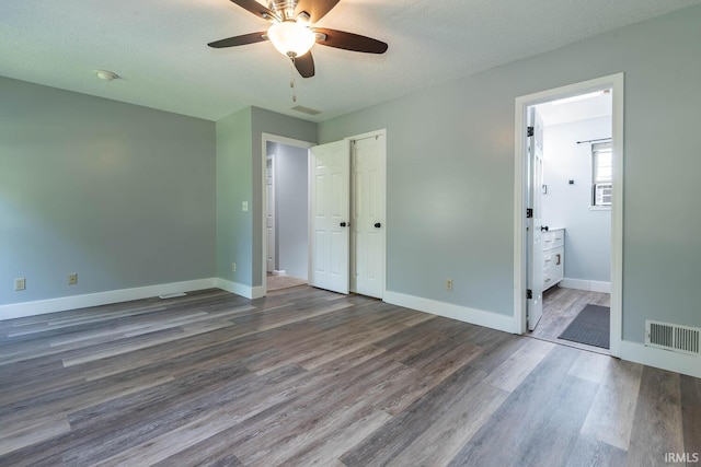3523 S Tulip Ave, Bloomington, IN 47403 - unfurnished bedroom with wood finished floors, connected bathroom, ceiling fan, a textured ceiling, and a closet