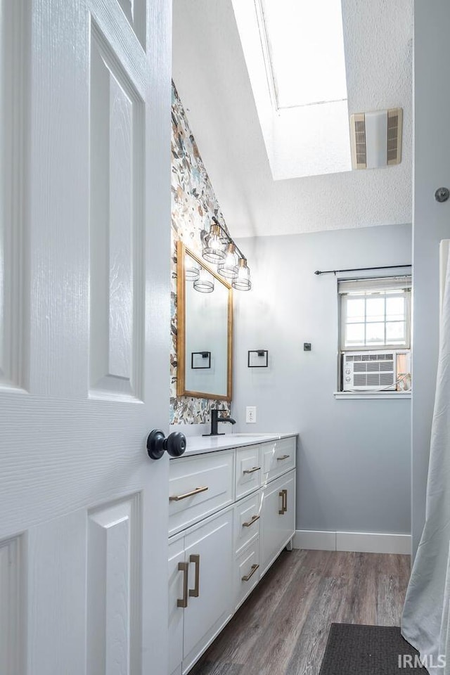 3523 S Tulip Ave, Bloomington, IN 47403 - full bathroom with a skylight, vanity, wood finished floors, and cooling unit