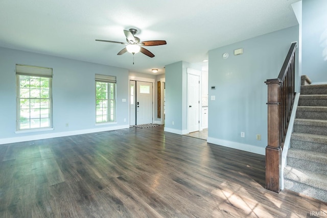 3523 S Tulip Ave, Bloomington, IN 47403 - unfurnished living room with ceiling fan, stairway, and dark wood-type flooring