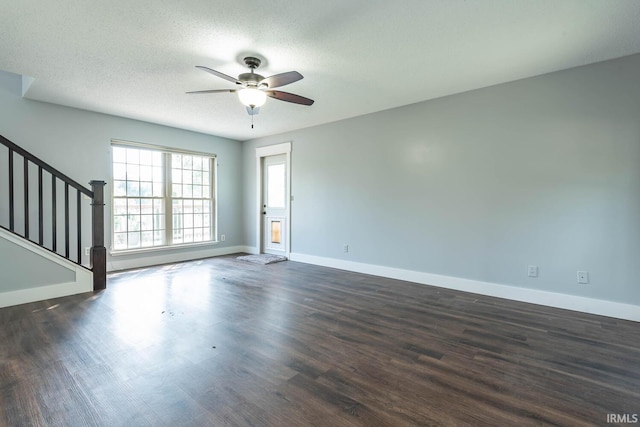 3523 S Tulip Ave, Bloomington, IN 47403 - unfurnished living room with ceiling fan, dark wood-type flooring, stairs, and a textured ceiling