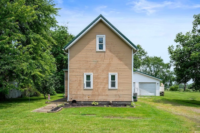 315 Mill St, Geneva, IN 46740 - view of side of home featuring an outbuilding, a lawn, and a garage